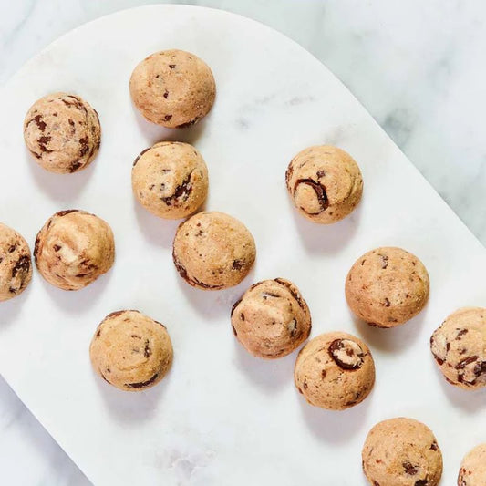 Byron Bay Cookies Milk Choc Chunk 100g pouch – golden cookies with milk chocolate chunks.