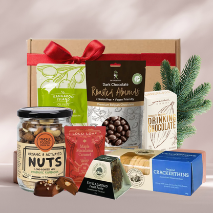 A Very Vegan Christmas gift box with activated nuts, dark chocolate almonds, Loco Love chocolate, olives and Crackerthins
