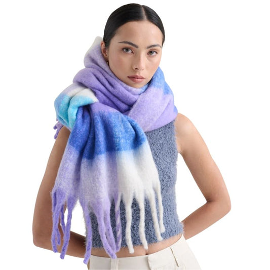 Woman wearing Betty Check Fluffy Scarf in lilac, blue and cream oversized pastel winter wrap with tassel fringe