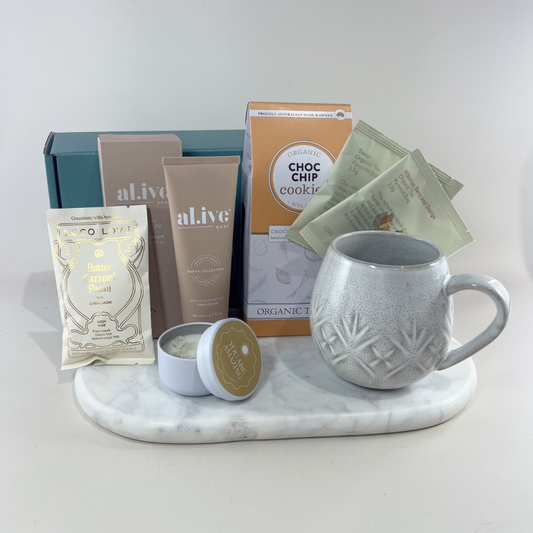 Carer gift box with speckled ceramic mug, Love Tea sachets, choc chip cookies, Al.ive Body hand cream, Loco Love chocolate and “You Are Amazing” candle