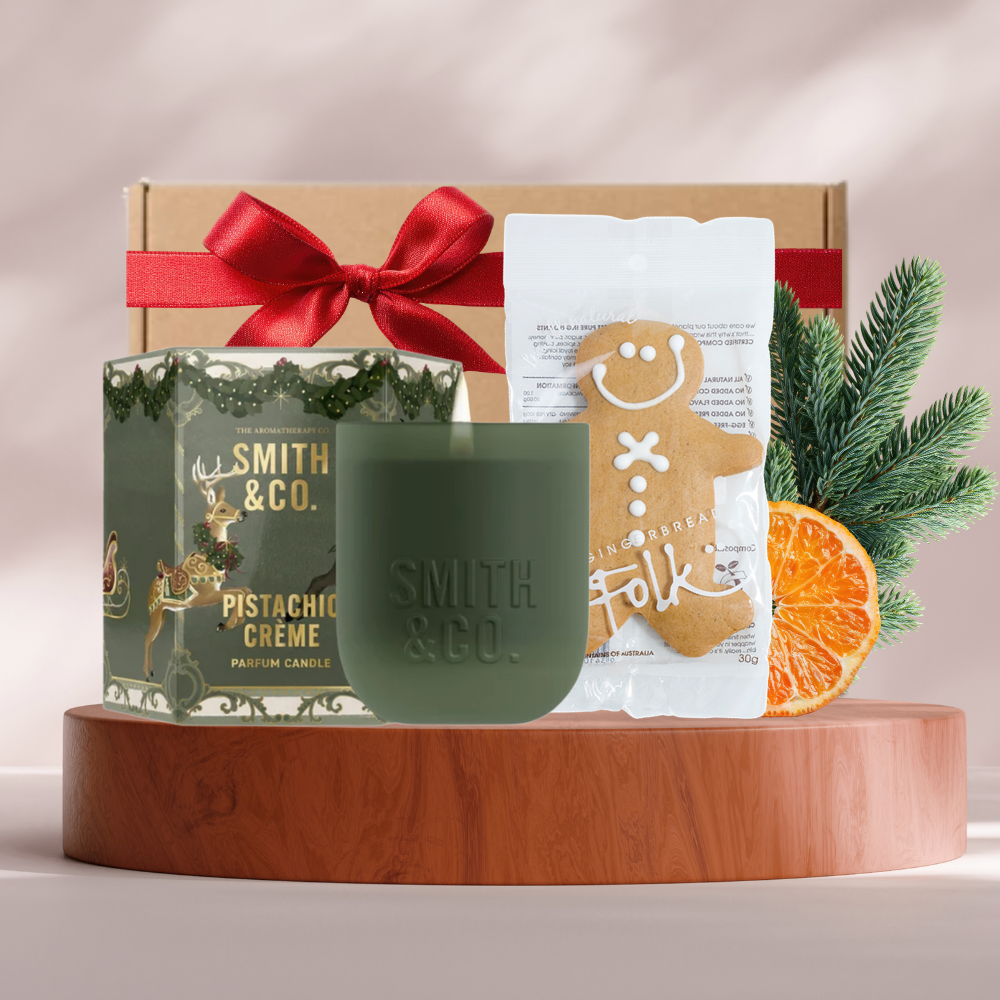 Christmas Light mini gift box with a Smith & Co. Pistachio Crème candle and a gingerbread man in a festive box with red ribbon
