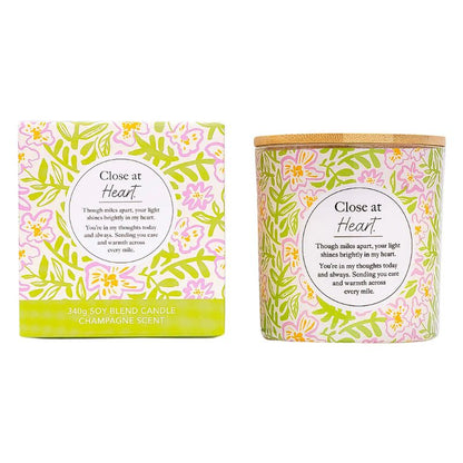 Close at Heart soy blend candle with floral packaging and champagne scent, presented in gift box and candle jar.