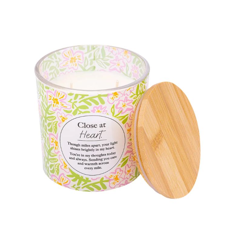 Close at Heart soy blend candle with floral packaging and champagne scent, presented in gift box and candle jar.