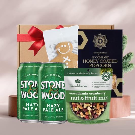 Hoppy Holidays Christmas gift box with two Stone and Wood Hazy Pale Ale cans, honey coated popcorn, Brookfarm nut mix and a gingerbread man
