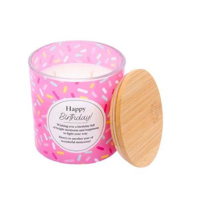 Pink Happy Birthday soy candle with champagne scent in a glass jar and matching gift box featuring a colorful confetti design