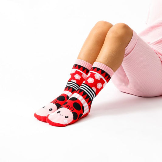 Cute red ladybug socks for kids with playful cartoon design and soft cotton fabric.