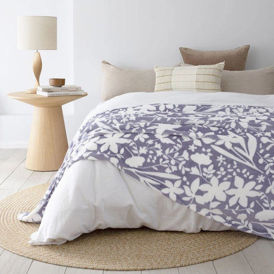 Blue and white floral fleece blanket with soft plush fabric and botanical pattern.
