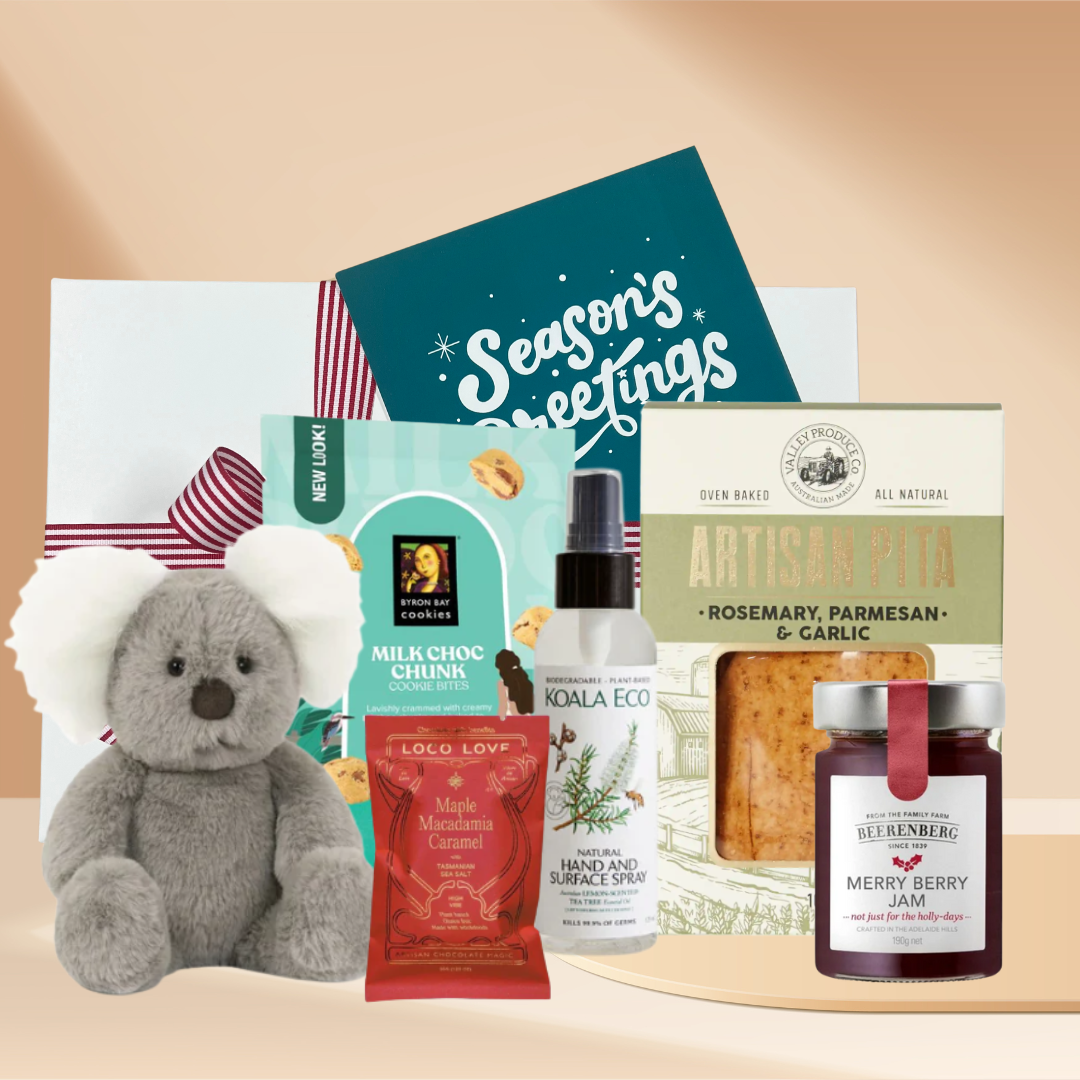 Australian gift box with koala soft toy, jam, pita snacks, eco room spray and chocolate arranged in a gift box.