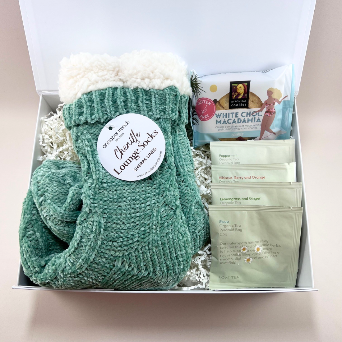 Mini Comforts Care Package gift box with sherpa-lined socks, organic Love Tea sachets and a Byron Bay white choc macadamia cookie