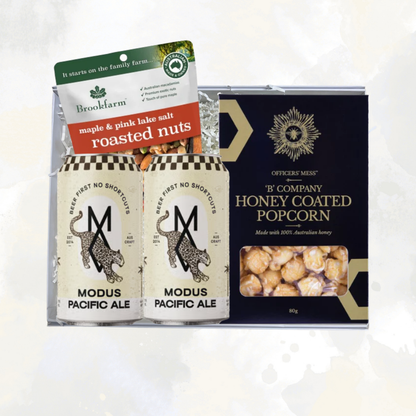 The Local Brew Box gift hamper with two cans of Modus Pacific Ale, Brookfarm maple and pink lake salt roasted nuts, and Officers' Mess honey coated popcorn, packaged in a Wishing You Well gift box.