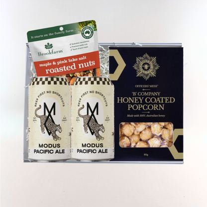 The Local Brew Box gift hamper with two cans of Modus Pacific Ale, Brookfarm maple and pink lake salt roasted nuts, and Officers' Mess honey coated popcorn, packaged in a Wishing You Well gift box.