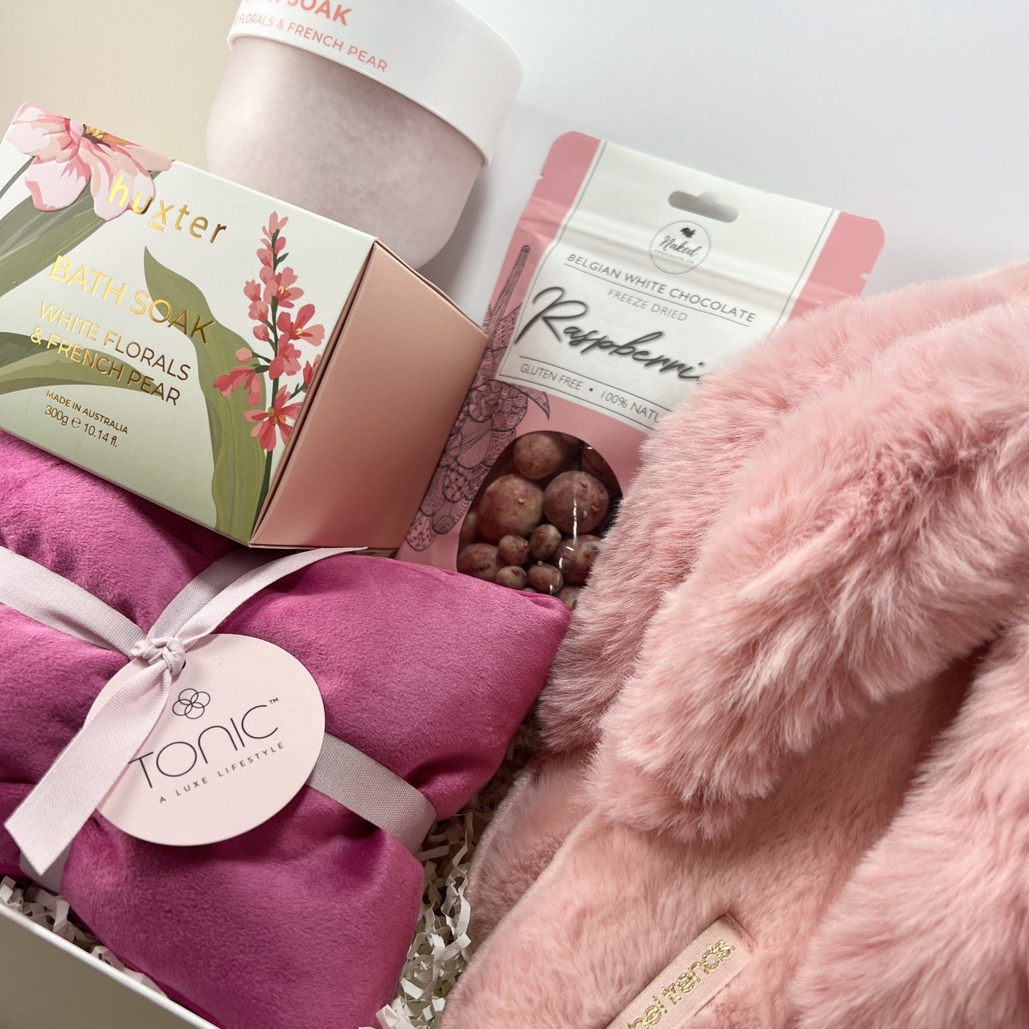 Women’s relaxation gift hamper featuring Huxter bath soak, Tonic heat pillow and cosy slippers