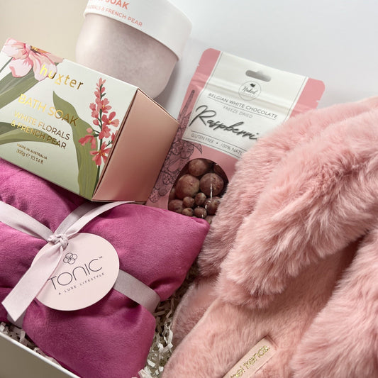Women’s relaxation gift hamper featuring Huxter bath soak, Tonic heat pillow and cosy slippers