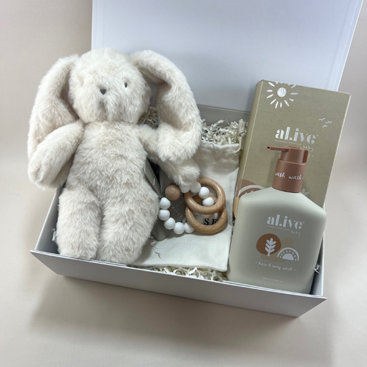 Image 1 — The Box Shot
New Baby Joy Gift Box with Alimrose cuddly bunny soft toy, Alimrose teether toy and Al.ive Baby gentle hair and body wash in a white gift box

