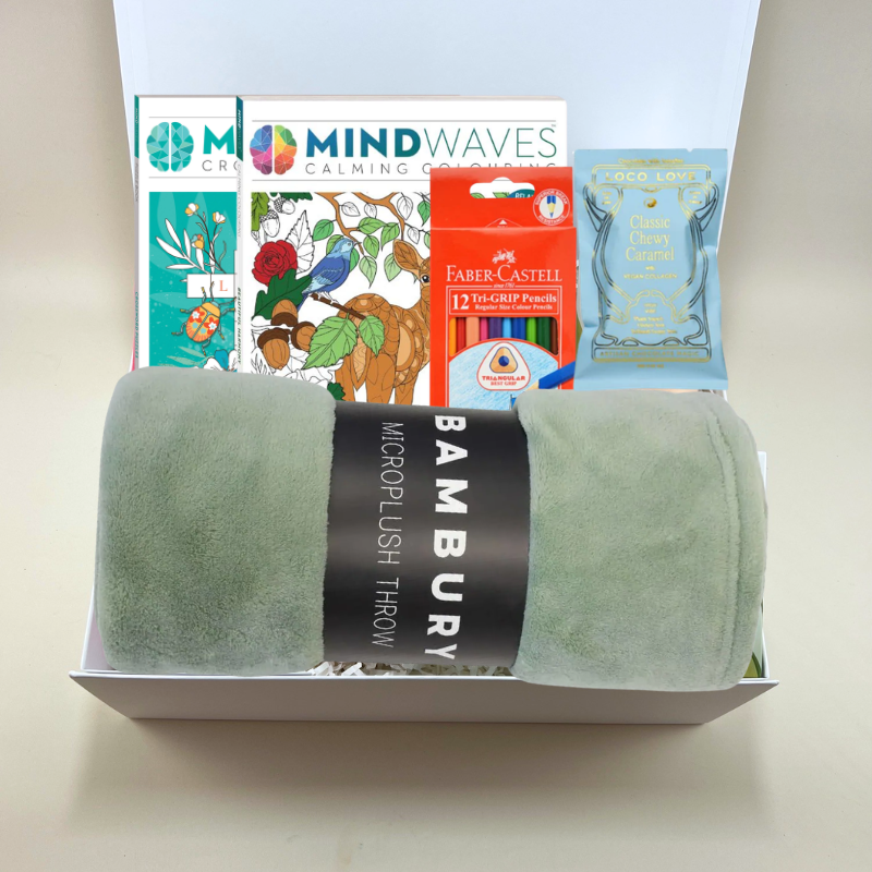 Relaxation gift box with a microfibre blanket, crossword book, colouring book, coloured pencils and Loco Love chocolate packaged in a gift box.
