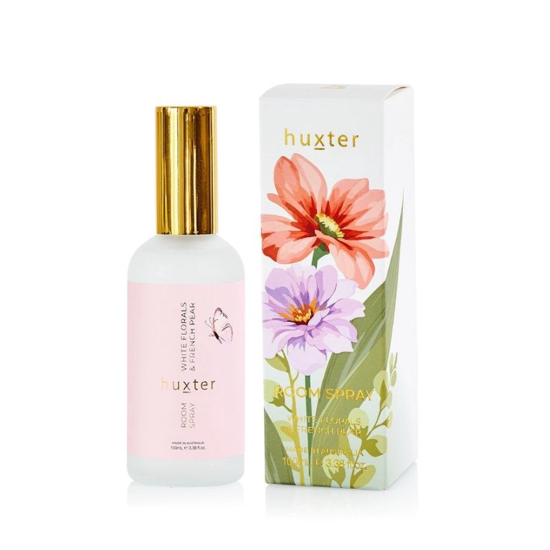 Huxter White Florals & French Pear room spray 100ml in frosted glass bottle with gold lid beside floral illustrated packaging.