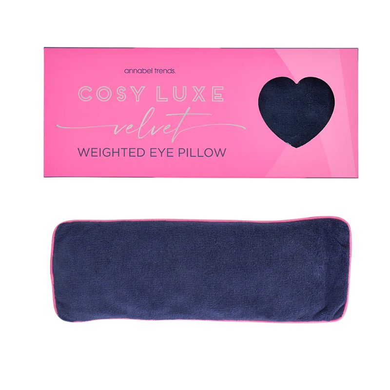 Sapphire blue velvet weighted eye pillow by Annabel Trends displayed below bright pink Cosy Luxe Velvet Weighted Eye Pillow packaging.
