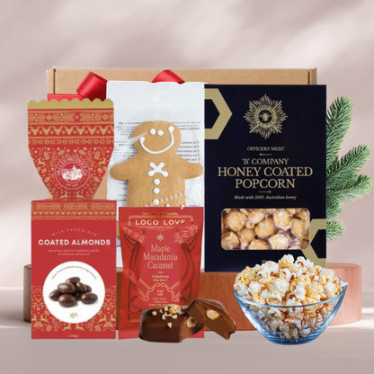 Sweet Gourmet mini Christmas gift box with chocolate almond bon bons, Loco Love chocolate, honey popcorn and a gingerbread man
