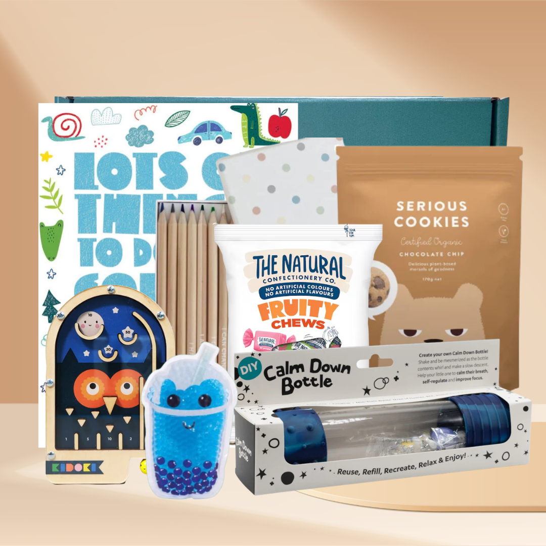 The Calming Sensory Kids Gift Box with activity book, Mindful and Co Kids coloured pencils, wooden pinball game, calm down bottle, sensory cooling soother and Serious Cookies choc chip