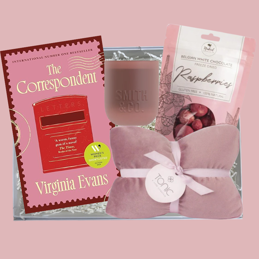 The Just One More Chapter Gift Box with The Correspondent by Virginia Evans, Smith and Co pink candle, Tonic blush heat pillow and Naked Harvest Belgian white chocolate freeze dried raspberries