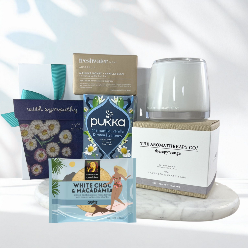 Thinking of You sympathy gift box with a calming lavender candle, forget-me-not seed packet, chamomile herbal tea, manuka honey soap bar, white chocolate macadamia cookie and a 