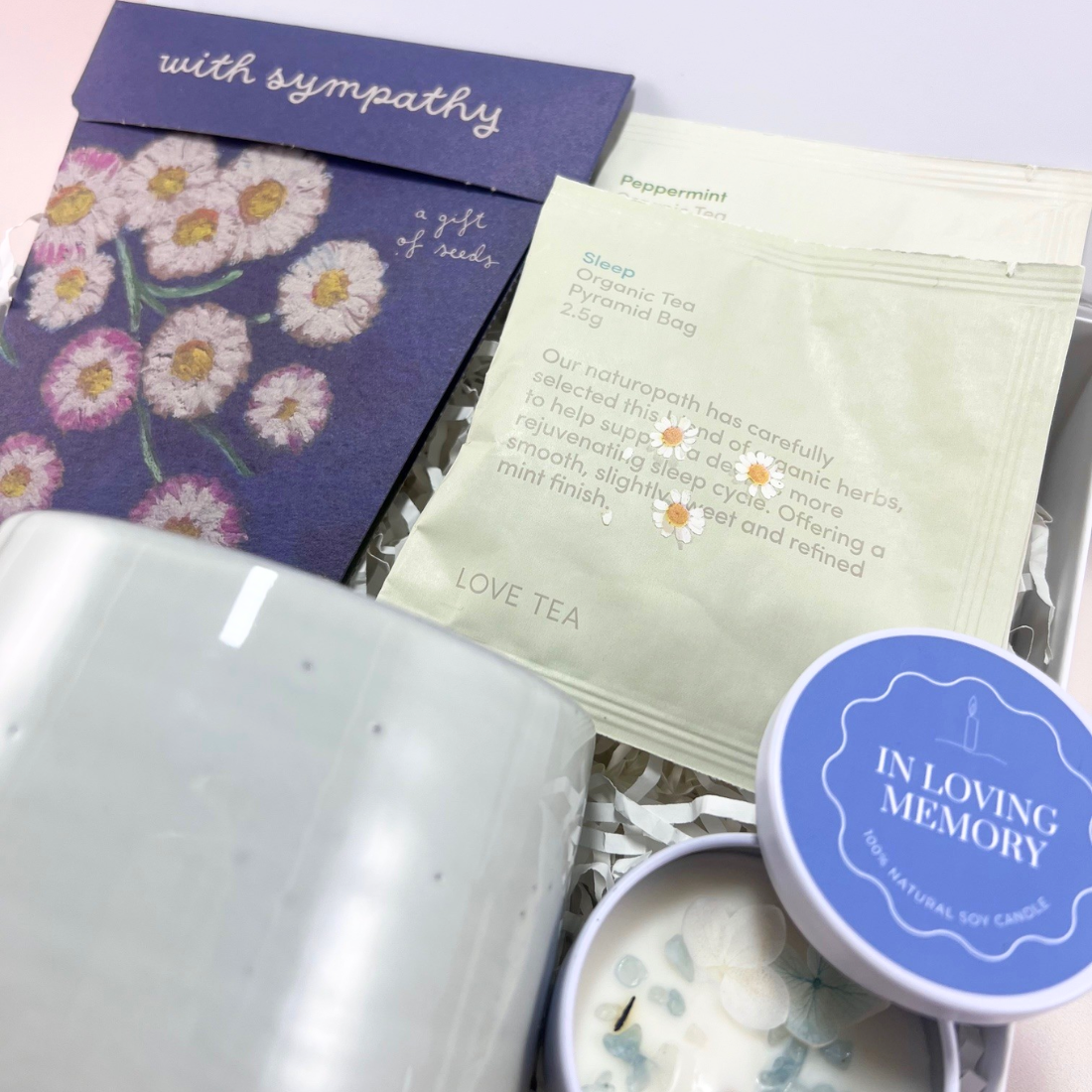 Close up: With Sympathy Gift Box containing Sow n Sow wildflower seeds, Ecology comfort mug, crystal and dried flower memory candle and Love Tea organic tea sachets.