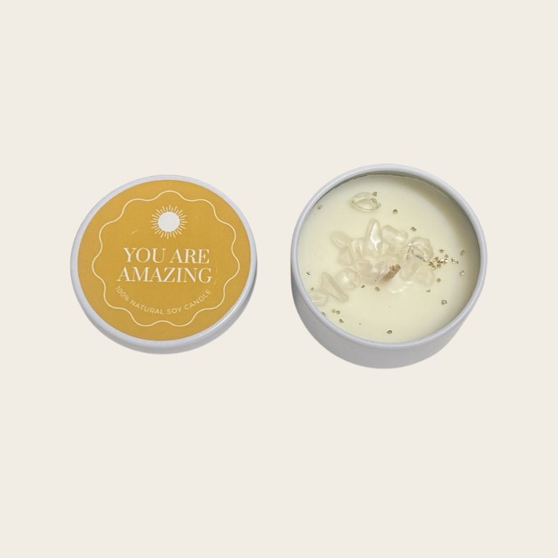 You Are Amazing crystal soy candle in white tin with yellow affirmation label and decorative crystal chips.