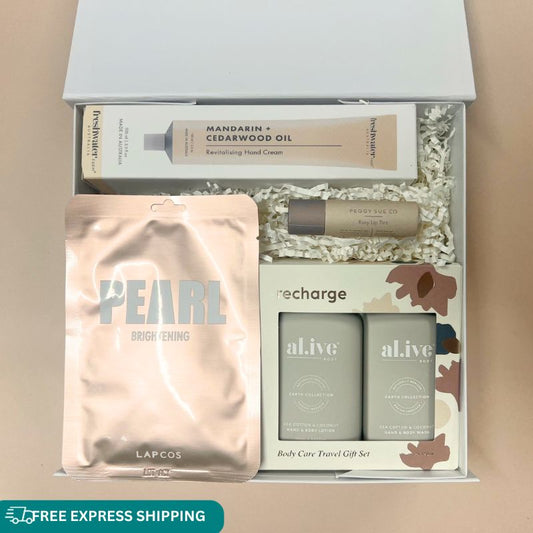 Pearl pamper gift box for her. Lapcos face mask, travel body care set, rose lip balm and mandarin hand cream.