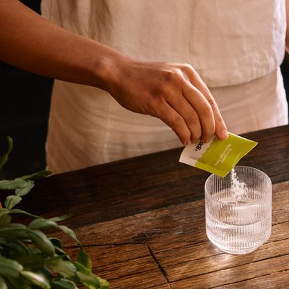 Sodii Hydration Sachets. Woman pouring sachet into water.
