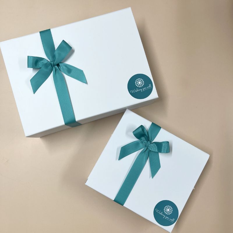 white gift box with teal ribbon